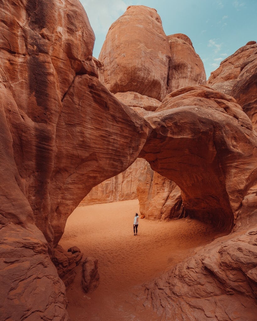 Girl hiking Sand Dune Arch on an Arizona Utah Road Trip