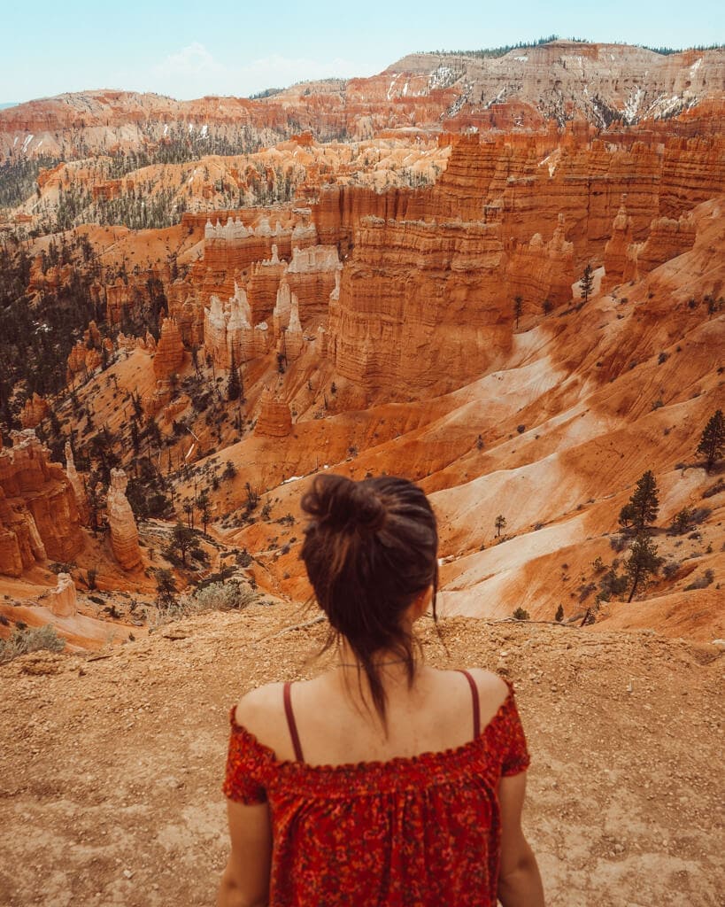 female looking at the orange rocks over bryce canyon national park