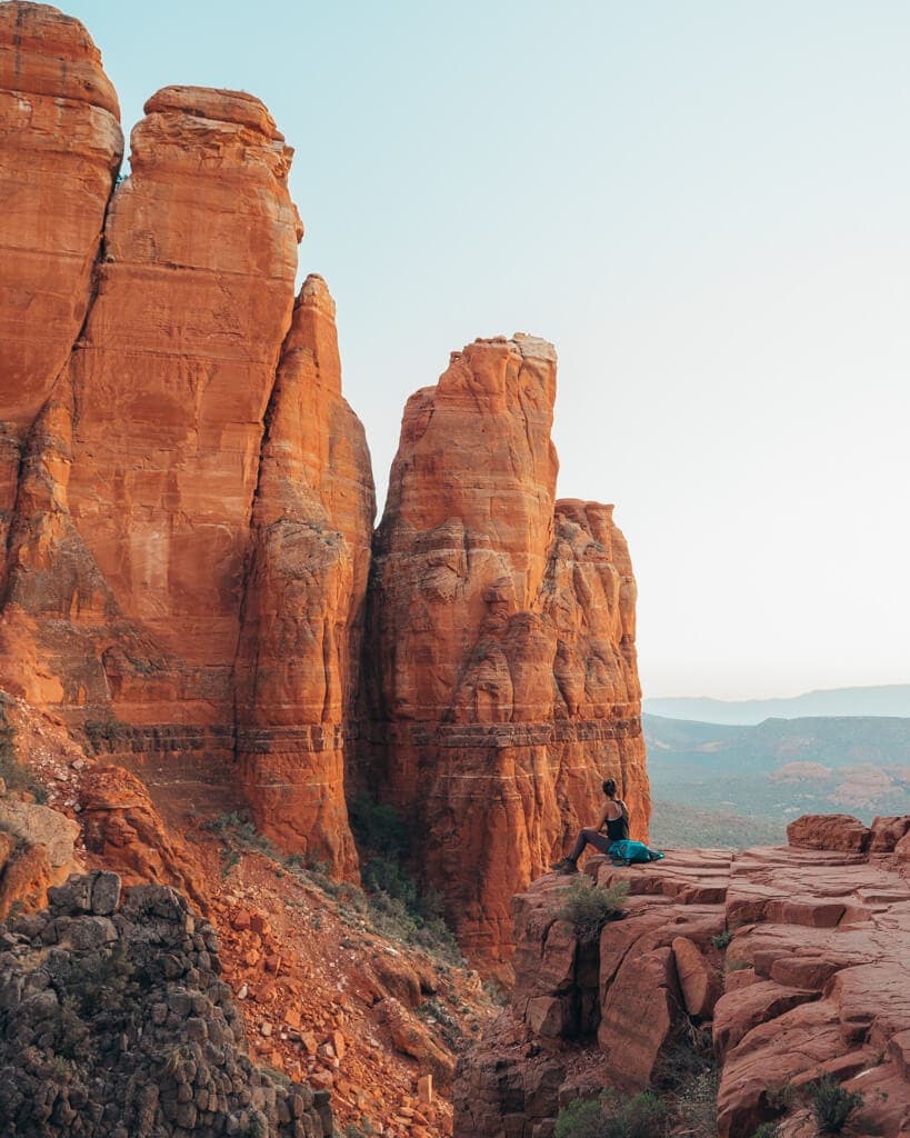 female hiker watching sunset over Cathedral Rock Sedona