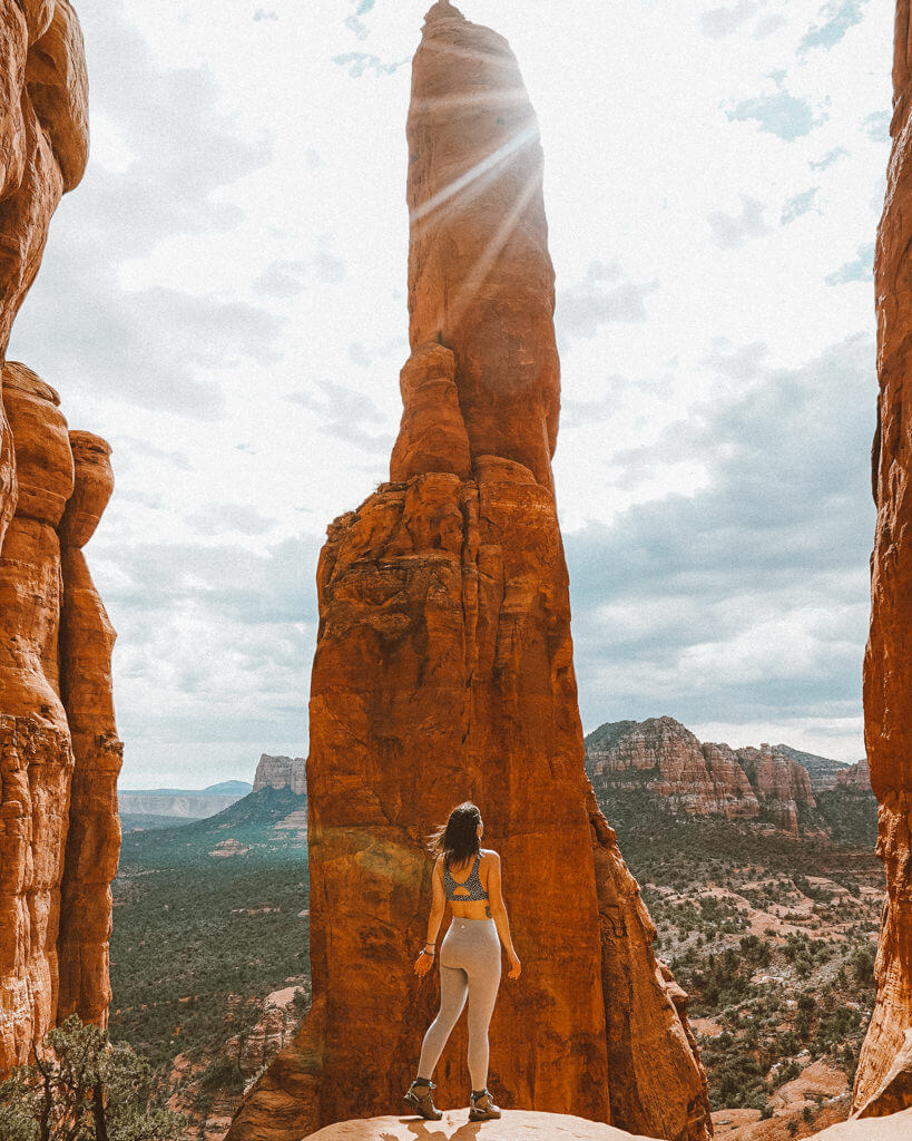female hiker looking at the red rock views over cathedral rock vortex in sedona