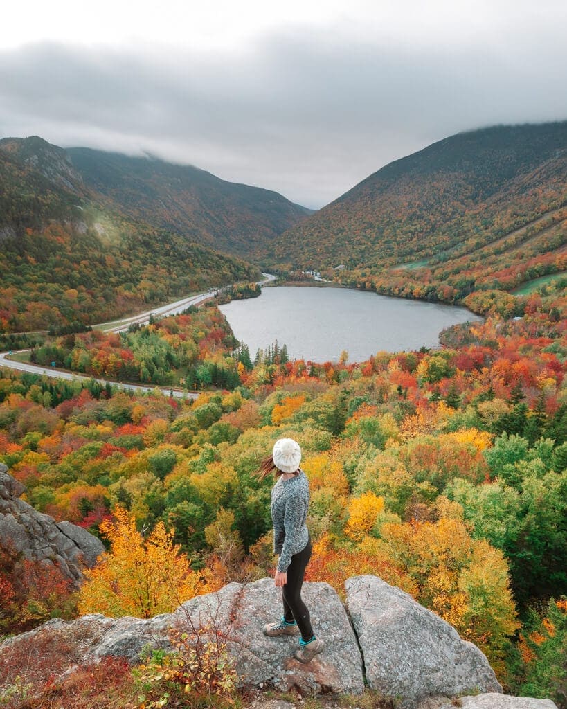 girl looking at fall foliage on artist bluff trail in franconia notch state park new hampshire