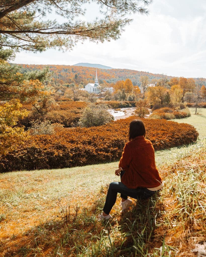 girl looking at new england fall foliage around stowe vermont